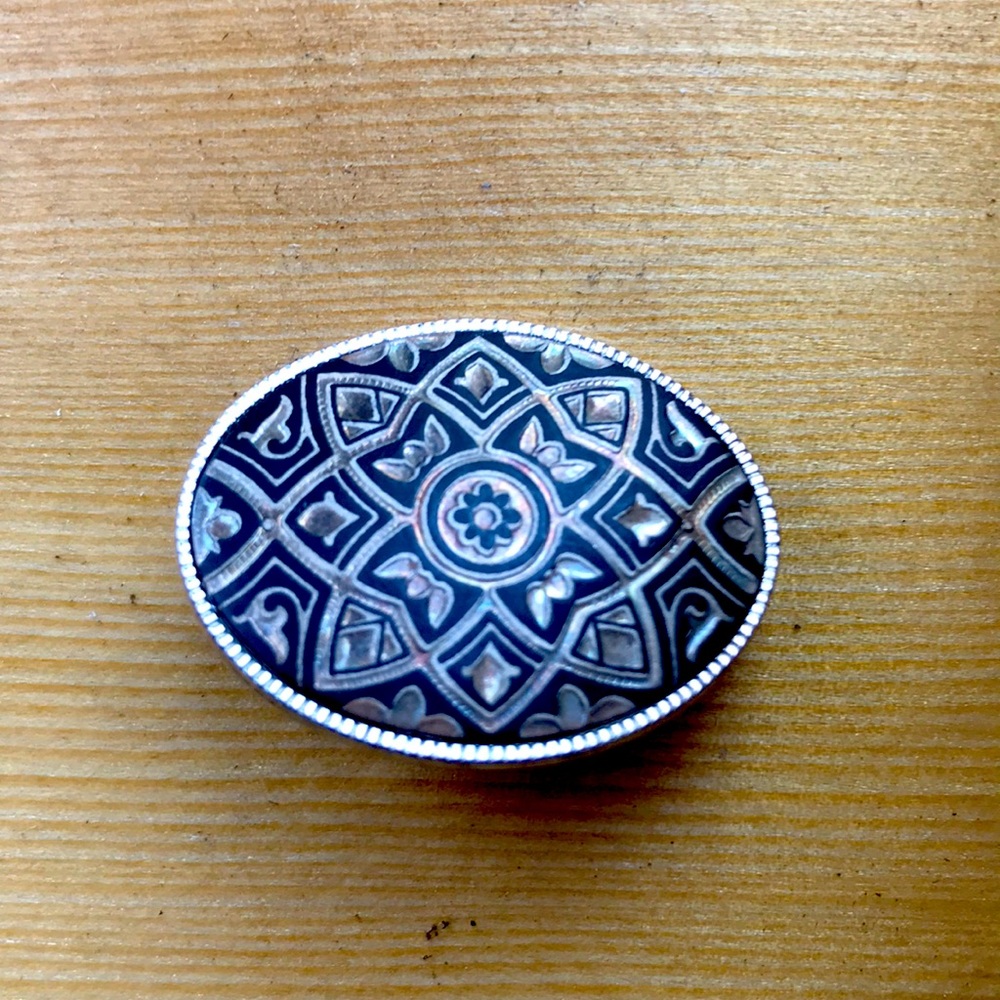 Silver and black oval brooch